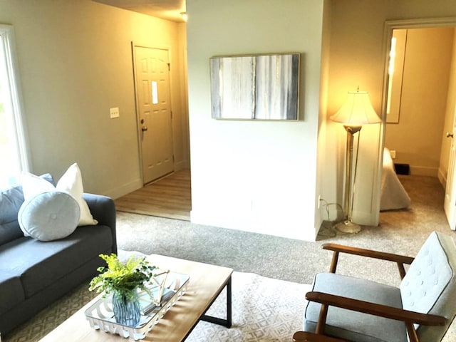 living room featuring light carpet and plenty of natural light