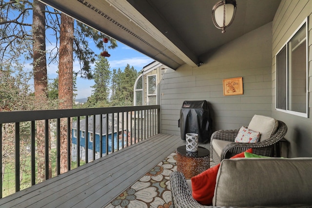 wooden terrace with a water view and area for grilling