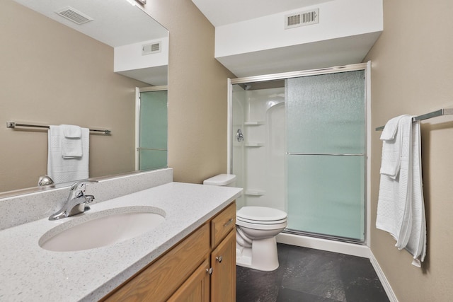 bathroom featuring vanity, an enclosed shower, and toilet