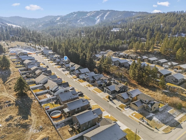 aerial view featuring a residential view, a mountain view, and a view of trees