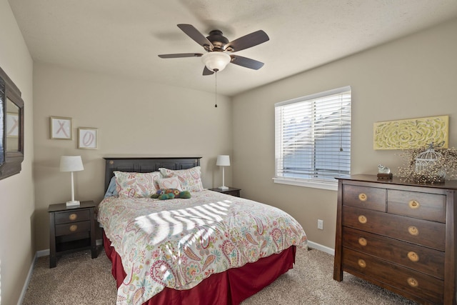 carpeted bedroom with baseboards and a ceiling fan
