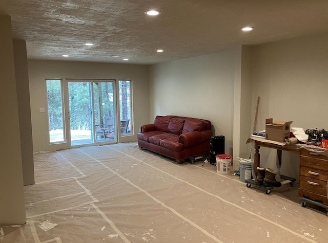 living room with a textured ceiling and recessed lighting