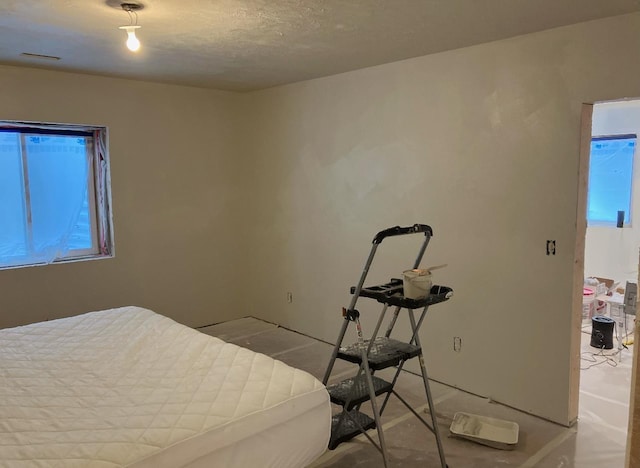 bedroom with visible vents and a textured ceiling