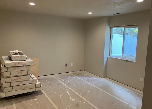 spare room featuring recessed lighting and visible vents