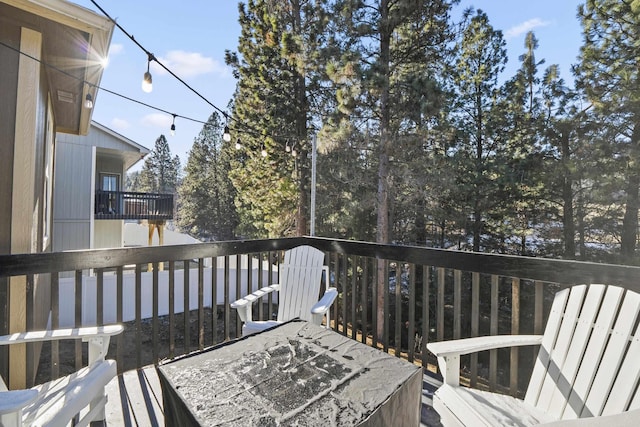 wooden terrace with a fire pit