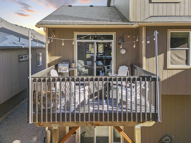deck at dusk featuring area for grilling