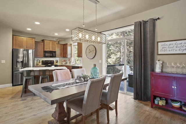 dining space with recessed lighting, light wood-type flooring, and plenty of natural light