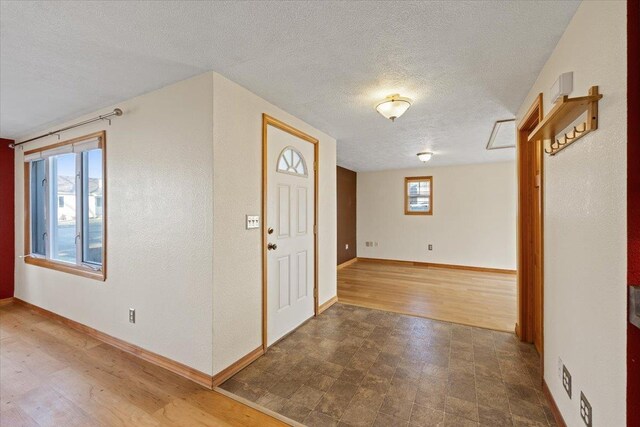 interior space featuring hardwood / wood-style flooring and a textured ceiling