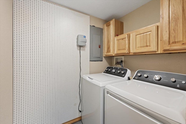 washroom with cabinets, separate washer and dryer, electric panel, and a textured ceiling