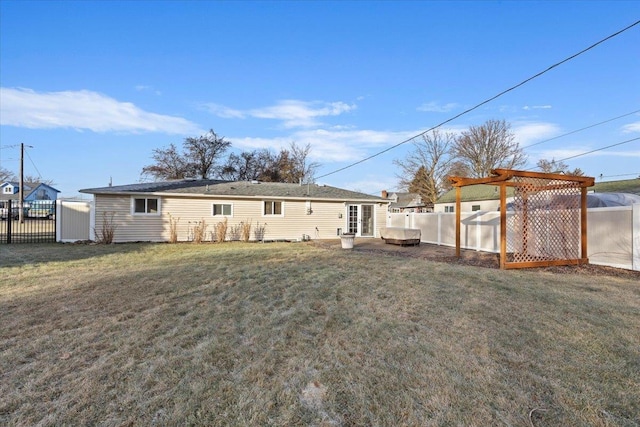 back of property with a pergola and a lawn