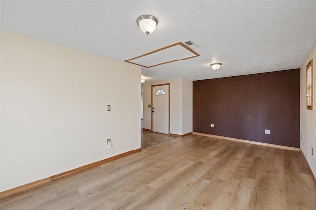 empty room featuring hardwood / wood-style floors and a textured ceiling