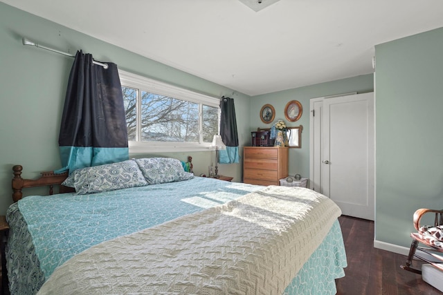 bedroom with dark hardwood / wood-style flooring