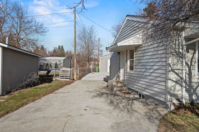 view of side of home featuring a trampoline