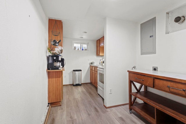 kitchen featuring electric stove, electric panel, and light wood-type flooring