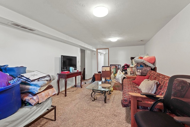 carpeted living room featuring a textured ceiling