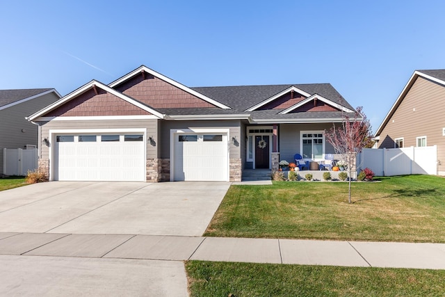 craftsman house featuring a garage, a front yard, and a porch