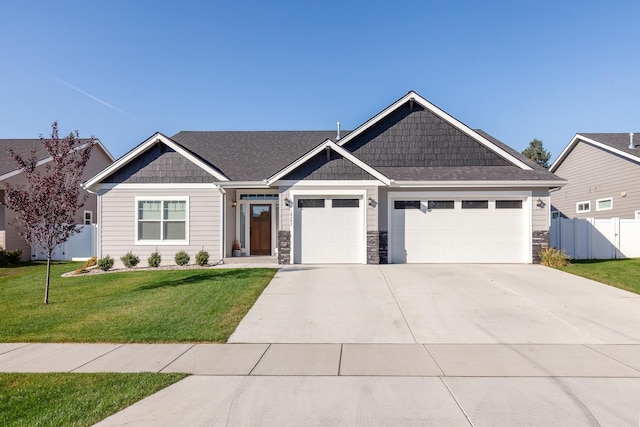 craftsman house with a garage and a front yard