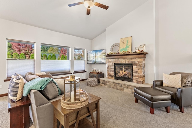 living room featuring vaulted ceiling, carpet, ceiling fan, and a fireplace