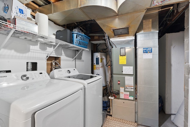 laundry room with electric water heater, heating unit, and independent washer and dryer