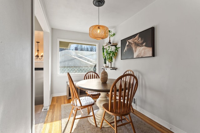 dining space with light hardwood / wood-style flooring