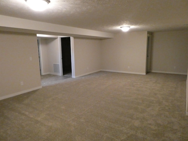 basement with carpet floors and a textured ceiling