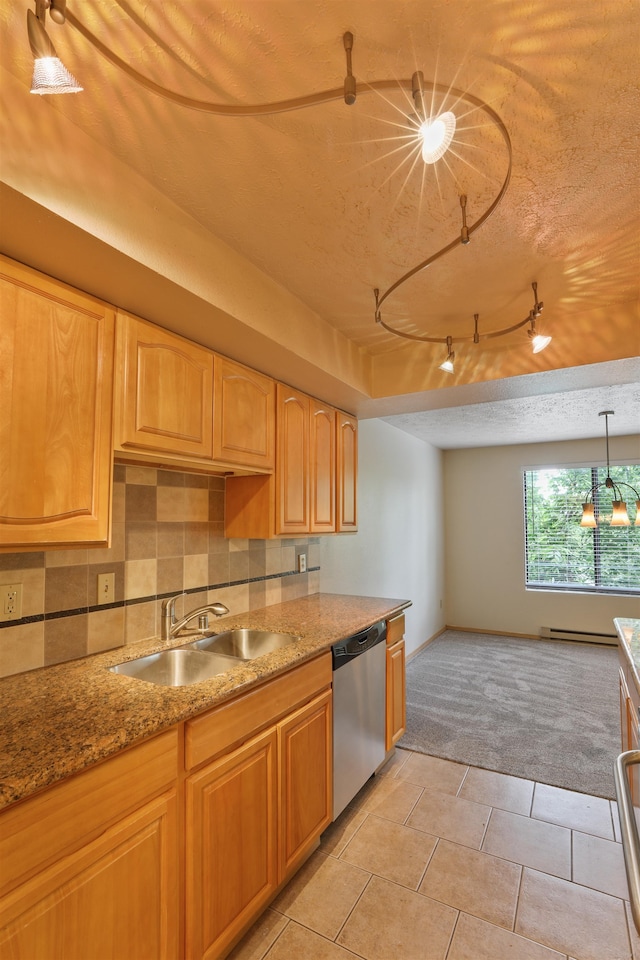 kitchen with pendant lighting, sink, a textured ceiling, light tile patterned flooring, and stainless steel dishwasher