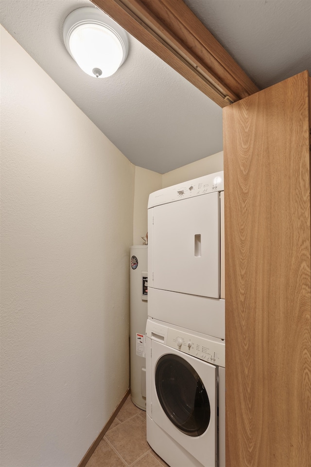 washroom featuring stacked washer and dryer, water heater, and light tile patterned floors