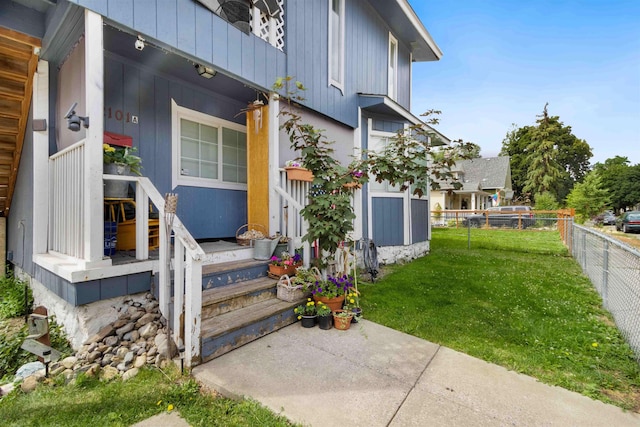 entrance to property featuring a yard