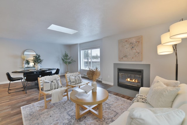 living room with a skylight and hardwood / wood-style floors