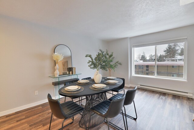 unfurnished living room featuring dark hardwood / wood-style flooring, a skylight, a textured ceiling, and baseboard heating