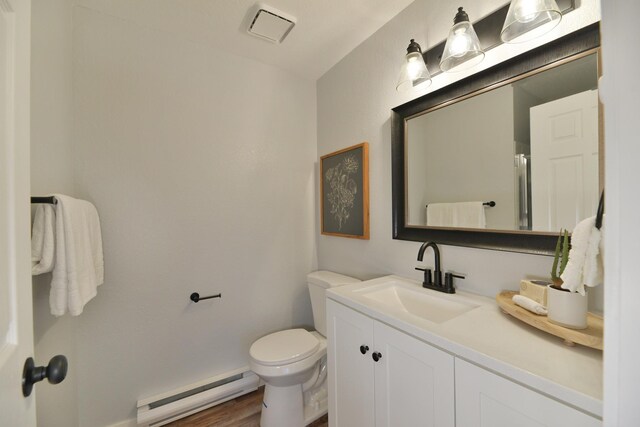 unfurnished bedroom with a textured ceiling, dark wood-type flooring, multiple closets, and baseboard heating