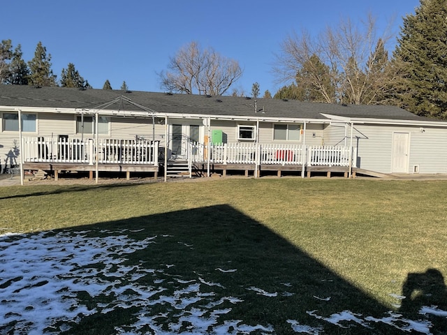 rear view of property with a wooden deck and a yard