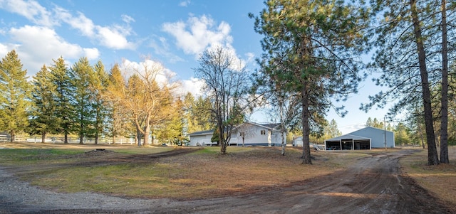 3732 E Westwood Ave, Chattaroy, WA 99003 - view of front of home with driveway, an outdoor structure, and a pole building