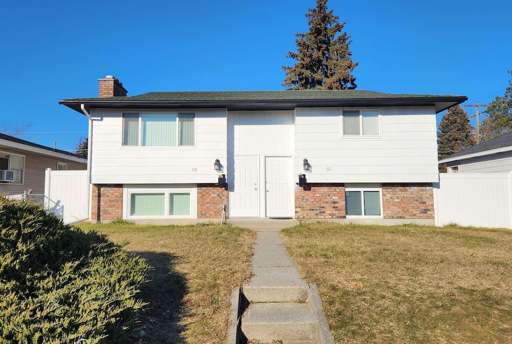 rear view of house featuring a yard