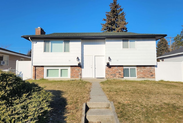 rear view of house featuring a yard