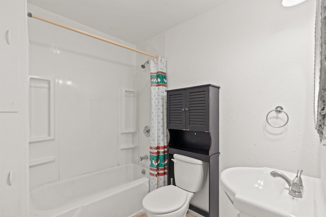 full bathroom with sink, shower / bath combo, and toilet