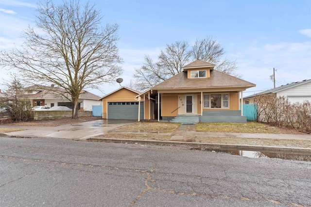 bungalow-style house with a garage and a porch