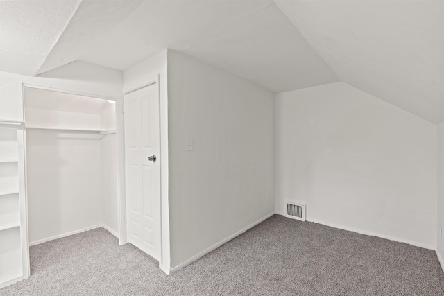 additional living space with lofted ceiling and carpet