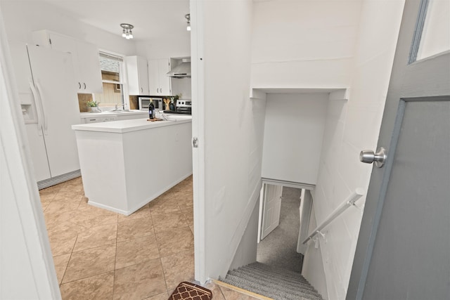 stairway with sink and tile patterned floors