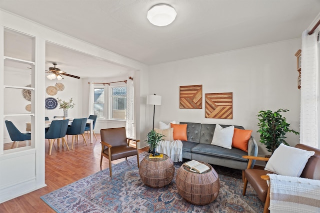 living room with wood-type flooring and ceiling fan