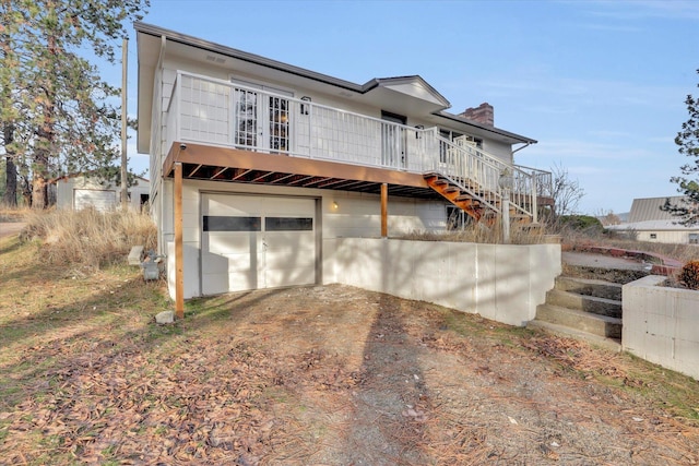 back of property with a garage