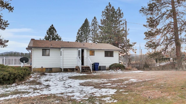 snow covered property featuring central AC