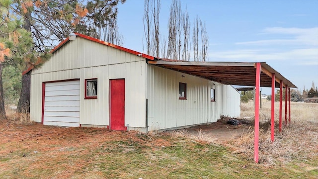 view of outbuilding with a carport and a garage