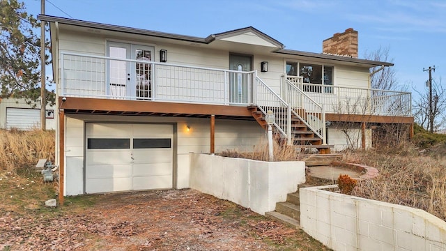 rear view of property featuring a garage