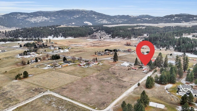 birds eye view of property featuring a mountain view