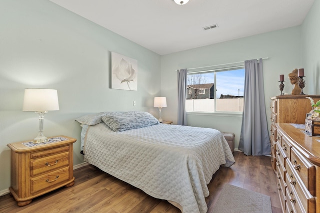 bedroom featuring dark hardwood / wood-style flooring