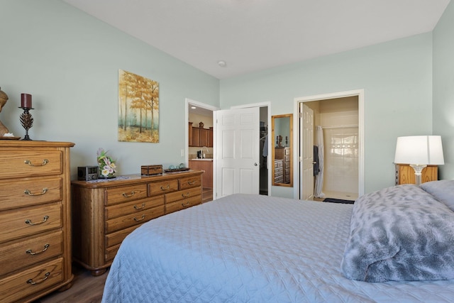 bedroom with hardwood / wood-style floors and ensuite bathroom