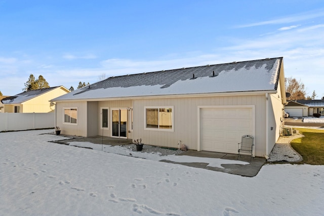 rear view of house with a garage