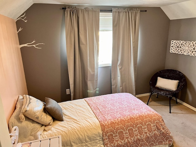 bedroom featuring carpet floors and vaulted ceiling