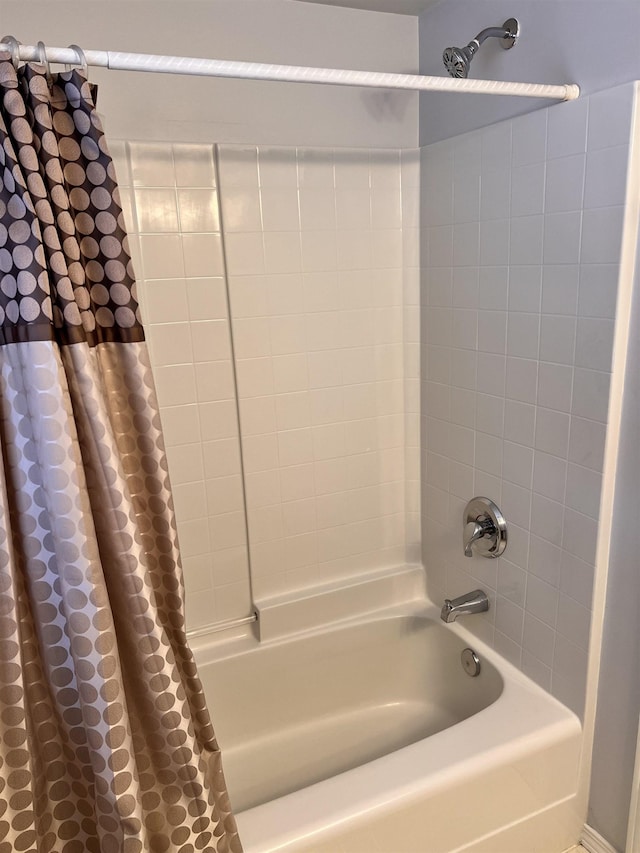 bathroom with shower / bath combo with shower curtain